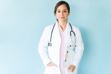 Portrait a confident female doctor with stethoscope and lab coat in a studio