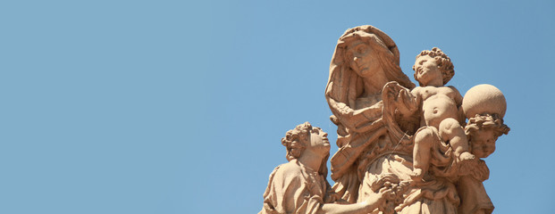 Ancient baroque statues of St Anne on the Charles' bridge. Prague, Czech Republic.