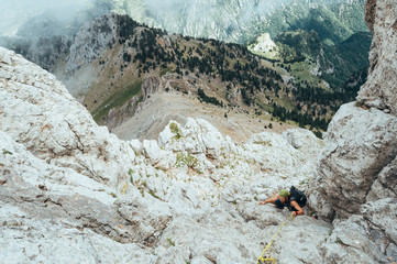 red-haired boy climbing a mountain