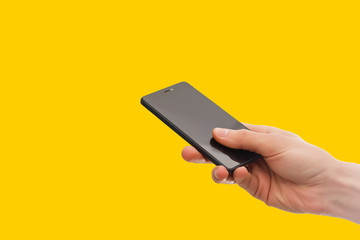 isolated hand holding the phone with isolated screen yellow, orange, background