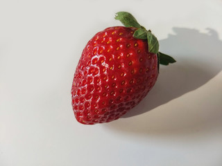 A strawberry on a table