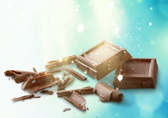 Broken chocolate bar on background