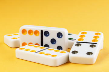 Domino on yellow background photo for your leisure projects or board games publications. Closeup.