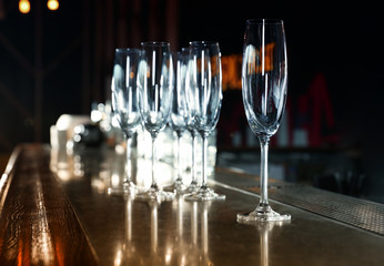 Empty clean champagne glasses on counter in bar