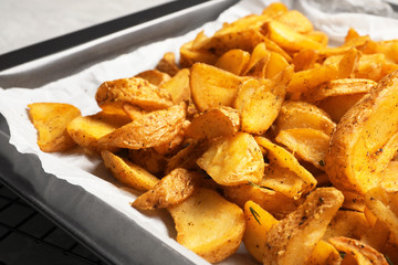 Sheet pan with delicious oven baked potatoes, closeup