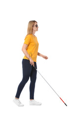 Blind woman in dark glasses with walking cane on white background