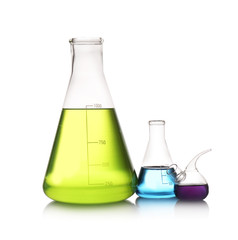 Set of lab glassware with color liquids isolated on white. Solution chemistry