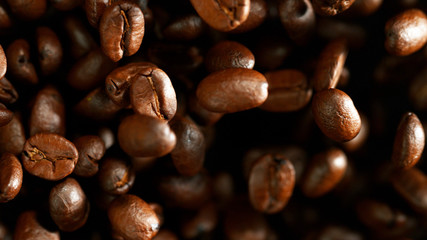 Coffee beans flying in the air, macro photo