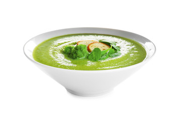 Bowl of broccoli cream soup with croutons on white background