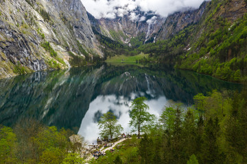 Naklejka na ściany i meble Scenic mountain panorama with green meadows and idyllic turquoise Lake Oberer