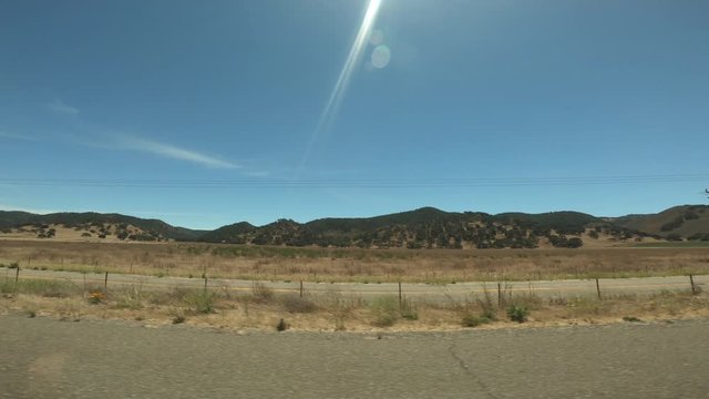 Wide Angle View Looking Out of Window from Car Driving Down Highway
