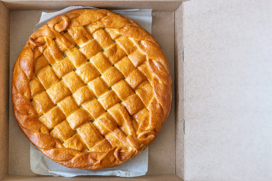 Traditional Homemade Rustic Baked Pie With Seasonal Fruit Or Meat Filling In Cardboard Box. Fast Food To Go. Bakery Delivery Menu. Flat Lay. Copyspace