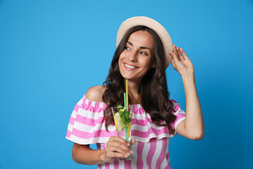 Young woman with refreshing drink on blue background