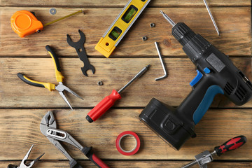 Set of repair tools on wooden background, flat lay