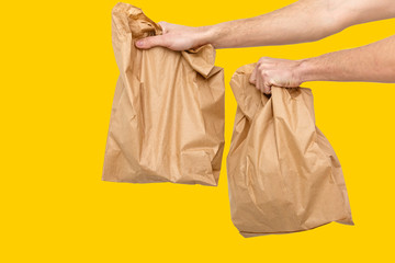 Diverse of paper containers for takeaway food. Delivery man is carrying yellow, orange, background