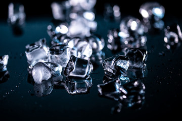 ice cubes reflection on black background. close up