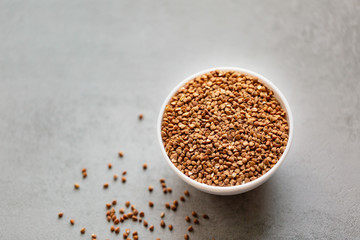Bowl of buckwheat isolated on white background. Top view.