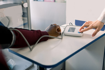 Close Up Of A Doctor Checking Blood Pressure Of A Patient. Doctor cardiologist measuring blood...