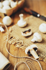 champignons, mushrooms in a wooden eco basket on a wooden background