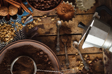 Roasted black and green coffee beans and ground coffee in the plate