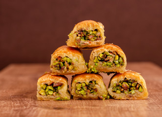 Turkish dessert baklava on wooden plate triangel