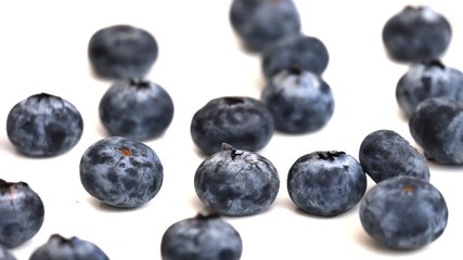 In selective focus a group of fresh blueberries on white isolated background