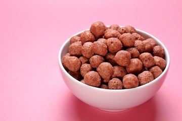 Chocolate breakfast in bowl isolated on pink background
