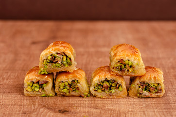 Turkish dessert baklava on wooden plate triangel