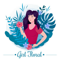 Cute girl with long romantic hair among the leaves and flowers of exotic plants in a T-shirt