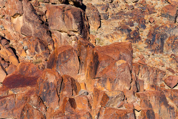 Red hematite from the formation of bound iron. Egypt. Mount Sinai in the morning at sunrise. Red-brown rocks in the mountains of the peninsula.	
