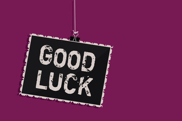 Word writing text Good Luck. Business concept for A positive fortune or a happy outcome that a person can have Hanging blackboard message communication information sign purple background