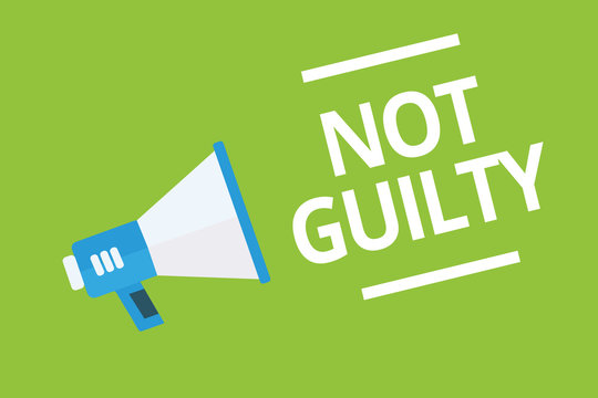 Handwriting text writing Not Guilty. Concept meaning someone is innocent didnt commit specific crime He free Megaphone loudspeaker green background important message speaking loud