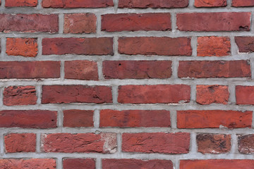 Red bright brick wall background. Large tiles. Textured wallpaper.