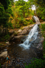 Tourist admire Huai Sai Luang waterfall in Doi Inthanon National Park near Chiang Mai Thailand