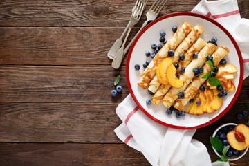 Sweet crepes filled with fresh blueberry and peach - Powered by Adobe