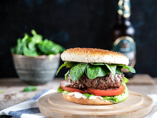 hamburger with leaves and beer bottle landscape image