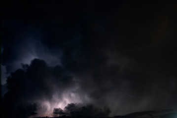 Obraz na płótnie Canvas Night clouds thunderstorm, light power in the sky, latin america, long exposure.