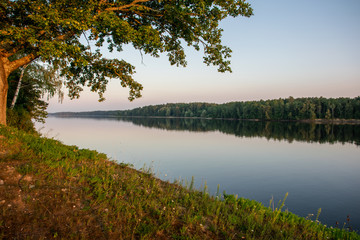 Calm river at sunset in summer