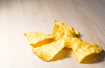 small piece of corn chip on wooden table