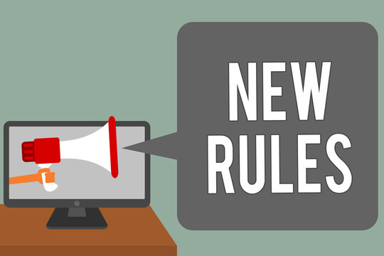 Writing note showing New Rules. Business photo showcasing A state of changing an iplemented policy for better upgrade Man hold Megaphone loudspeaker computer screen talking speech bubble