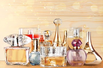 Various perfumes in bottles on a wooden table