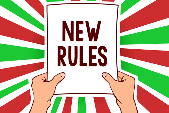 Writing note showing New Rules. Business photo showcasing A state of changing an iplemented policy for better upgrade Man holding paper important message remarkable red rays bright ideas