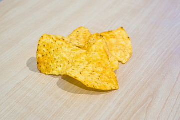 the pieces of corn chip on wooden table