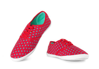 Red sneakers in green peas on an isolated white background