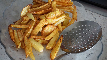 in the kitchen to make potato fries, fried potatoes for breakfast, chopped sliced potatoes, ready to be fried