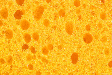 The texture of the bright yellow sponge closeup