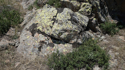 old rocks in nature  very old rock fragments with moss 