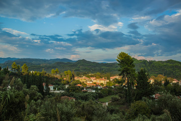top view Asian settlement in rainy forest scenic landscape natural environment hills in slightly cloudy sunset evening time 