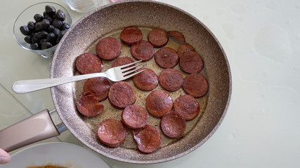 cooked sausages in a pan 
