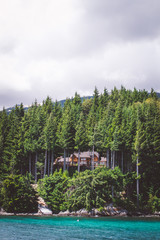 Naklejka premium House hidden in the middle of the woods, with a view of a lake in Bariloche, Patagonia Argentina